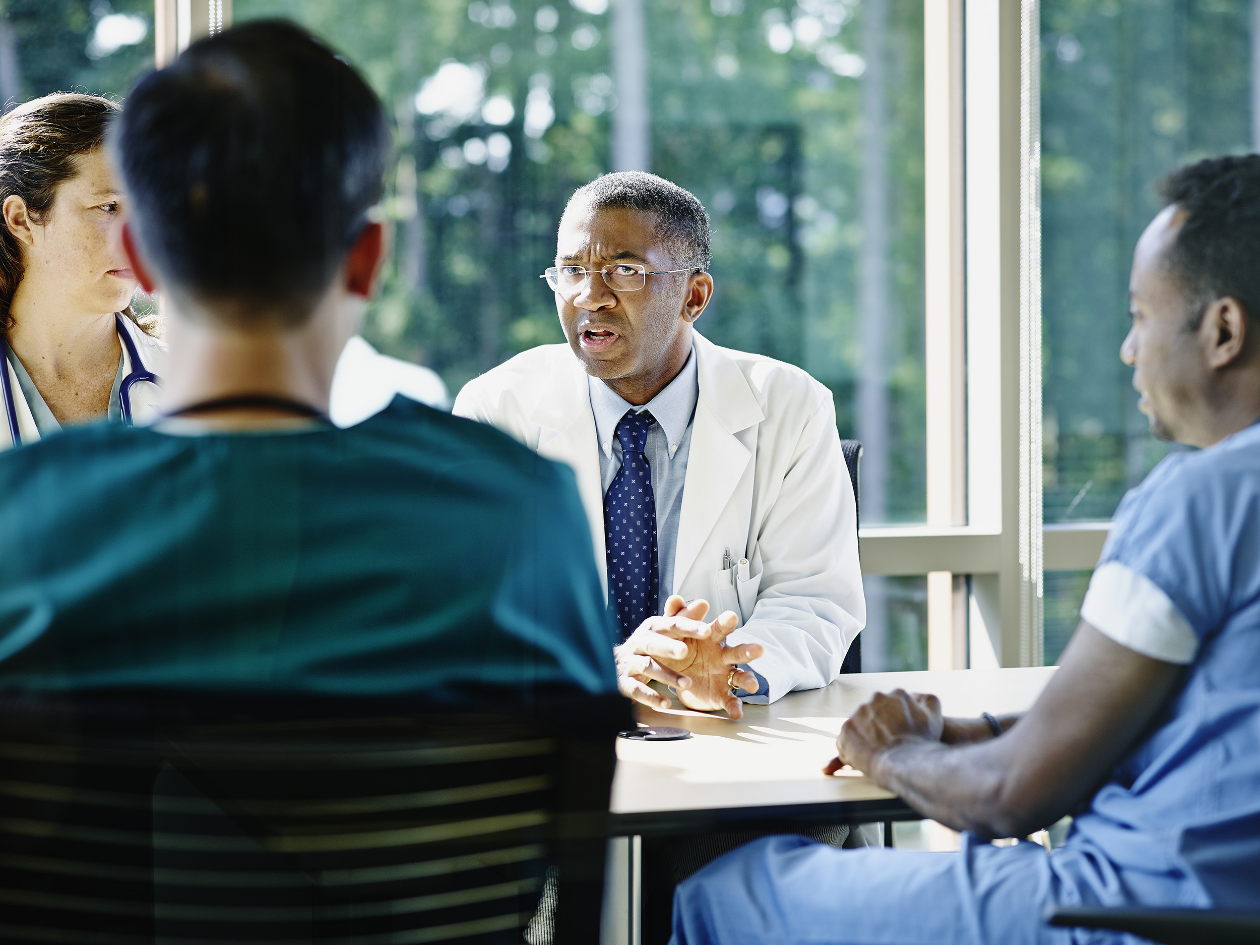A doctor leading medical team meeting.