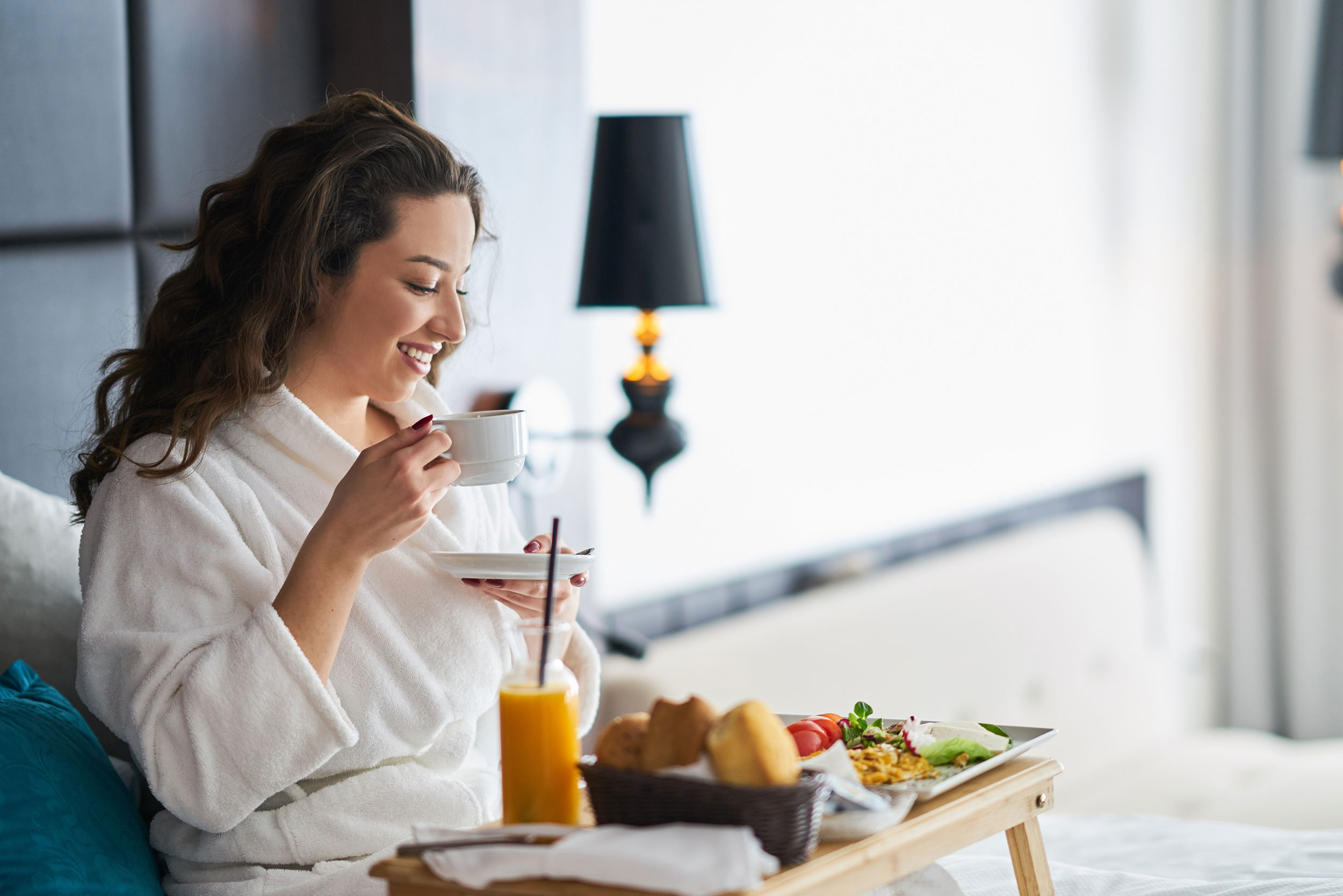 Breakfast in bed in a cozy hotel room.